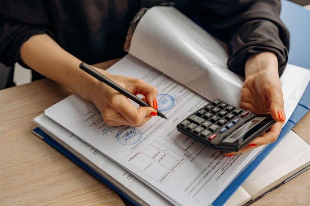 Accountant reviewing long term care insurance premium deductions with a calculator