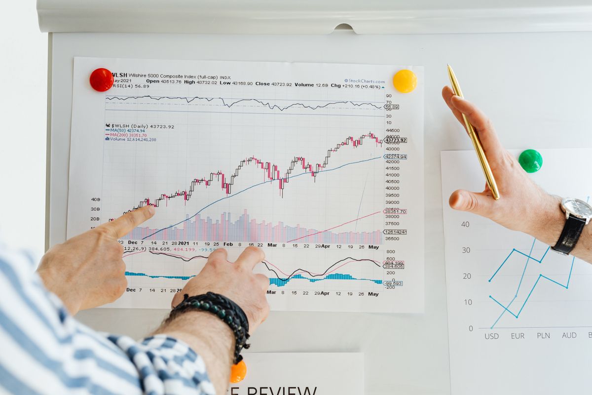Advisors analyzing investment portfolio growth charts, representing a $1 million plus asset base built by an executive