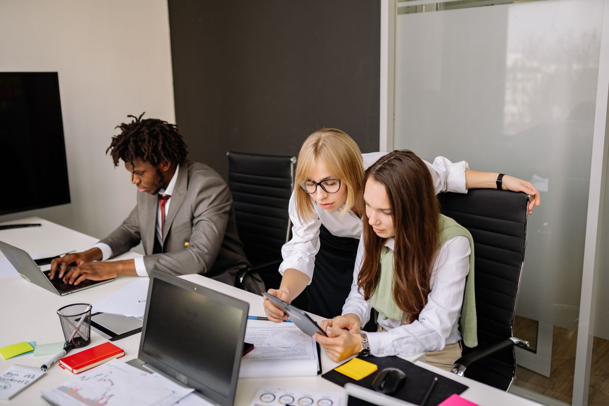Employees working together in an office, representing staff who become beneficial owners through an ESOP