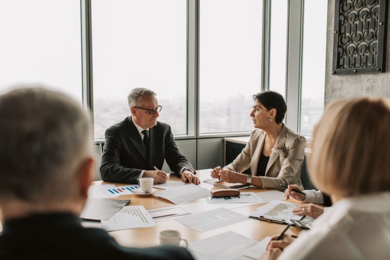 Business executives in a strategic meeting in a modern office, representing leadership a company wants to reward and retain