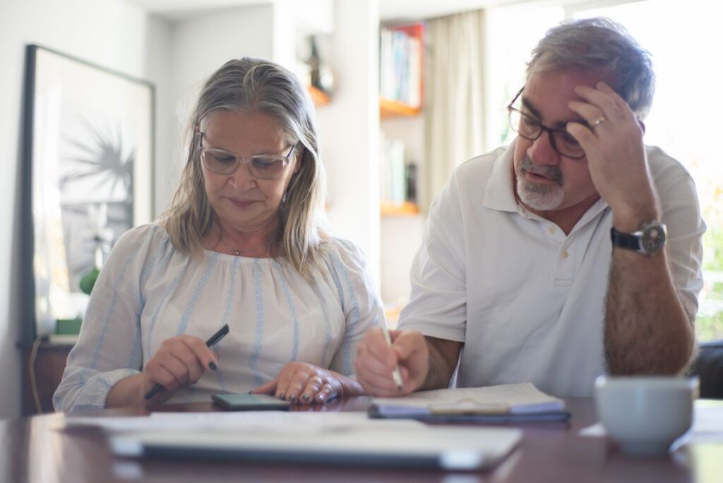 Senior couple reviewing their long term care and retirement income plan at home