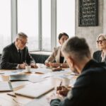 Business owner and executives comparing phantom stock, stock options, and equity options in a boardroom meeting