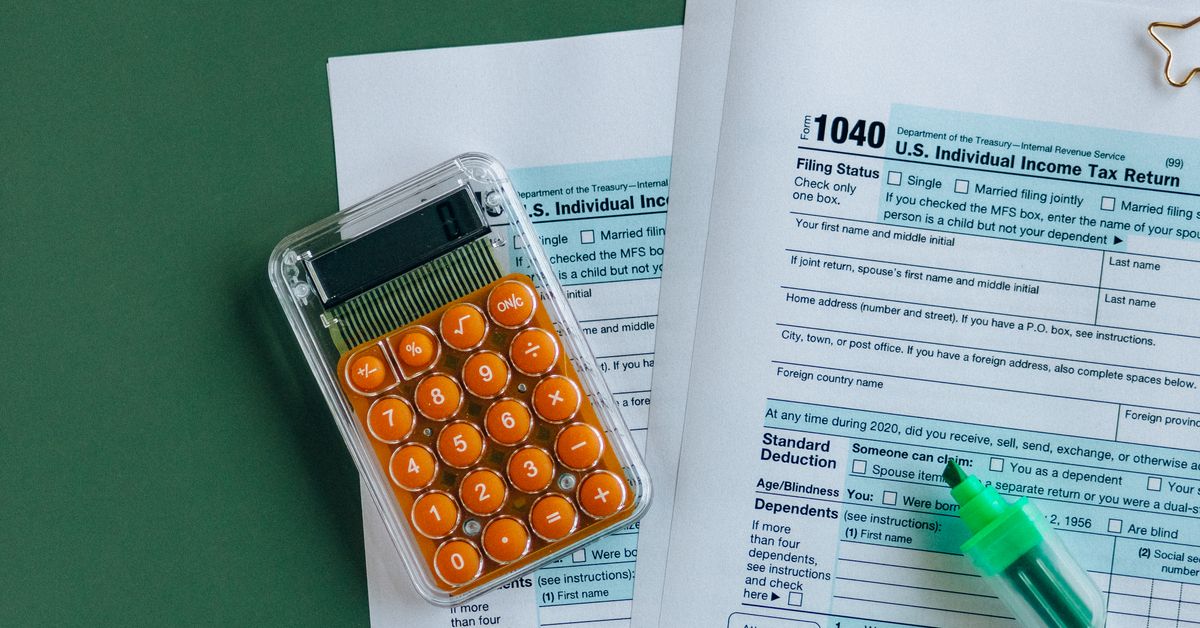 Tax return and calculator representing tax structuring before a business sale