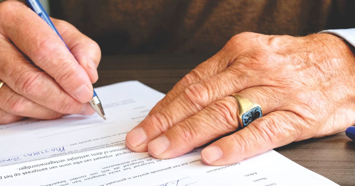 Business owner signing estate planning documents before a sale