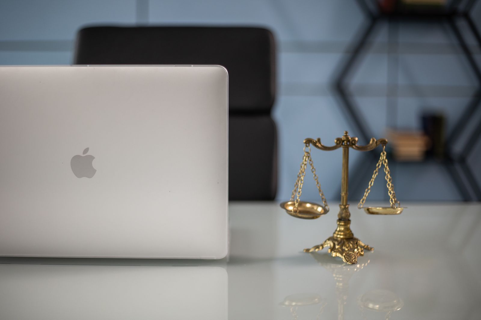 Scales of justice beside a laptop representing IRC 409A compliance rules