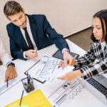 Business owners and executives reviewing phantom stock plan documents in a meeting