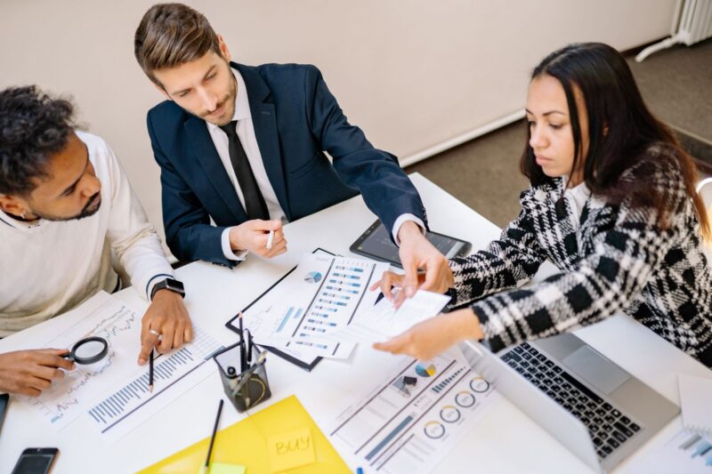 Business owners and executives reviewing phantom stock plan documents in a meeting