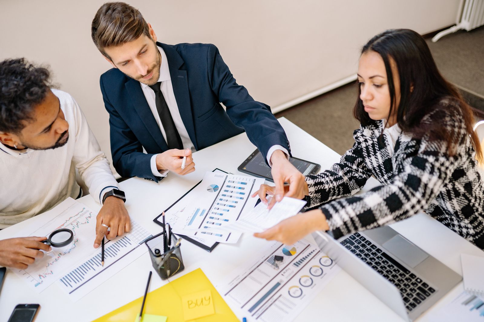 Business owners and executives reviewing phantom stock plan documents in a meeting