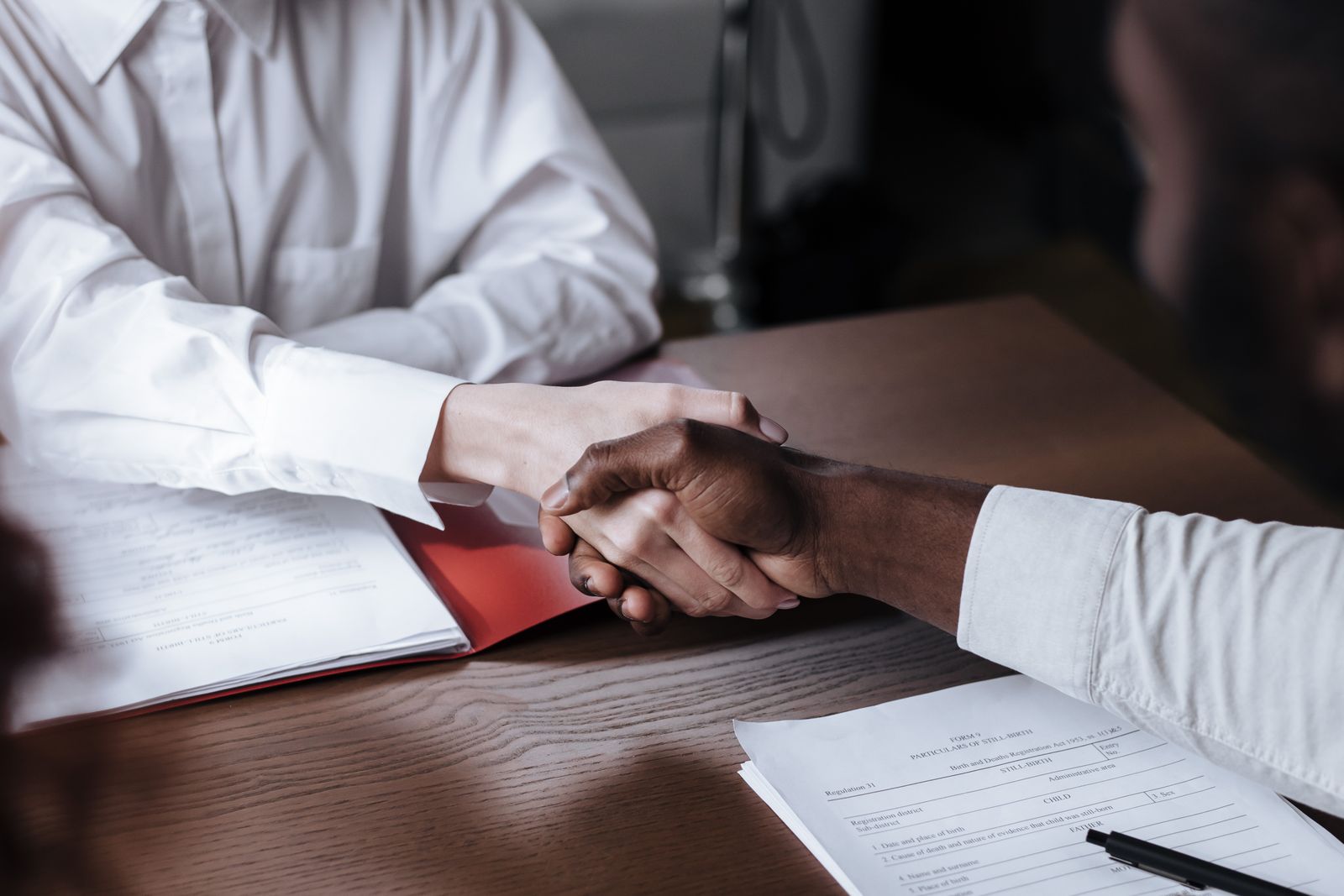Handshake over documents representing a funded phantom stock retention plan