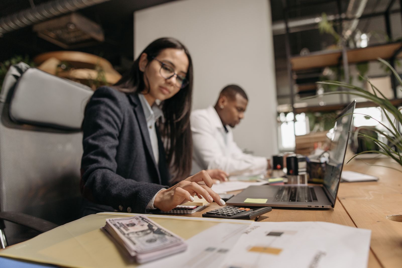 Finance staff calculating employer payroll tax and the deduction for a phantom stock payout