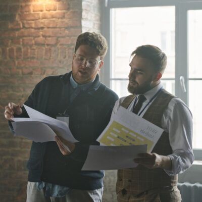 Business owner and advisor reviewing phantom stock plan documents at a mid-sized company