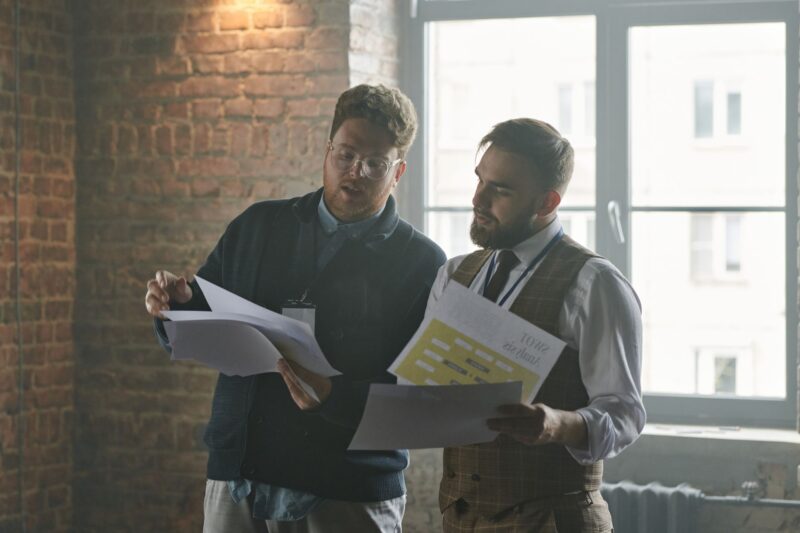Business owner and advisor reviewing phantom stock plan documents at a mid-sized company