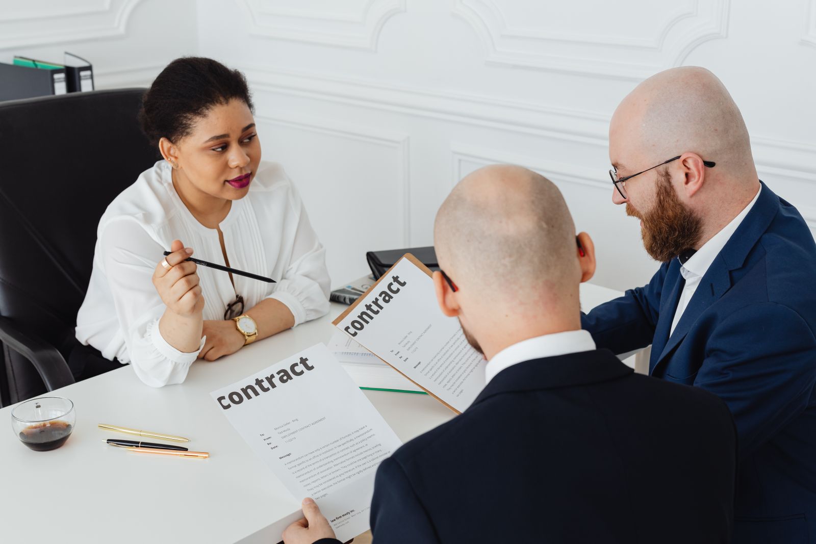 Advisors and a business owner reviewing phantom stock plan documents and tax treatment together