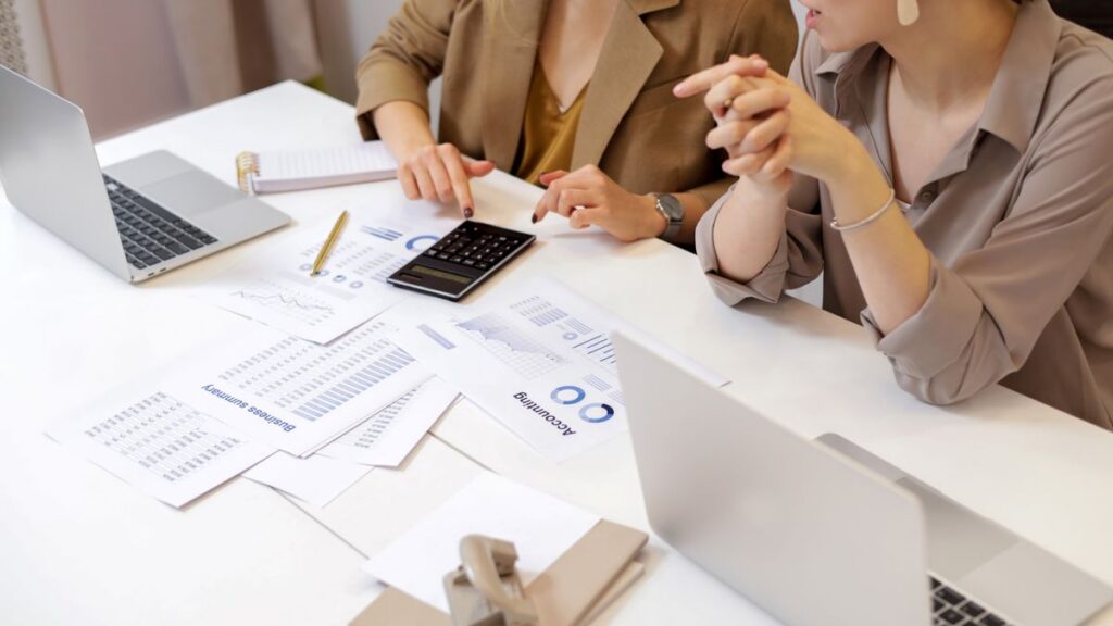 Business owners and advisors reviewing documents to plan 2027 executive benefits
