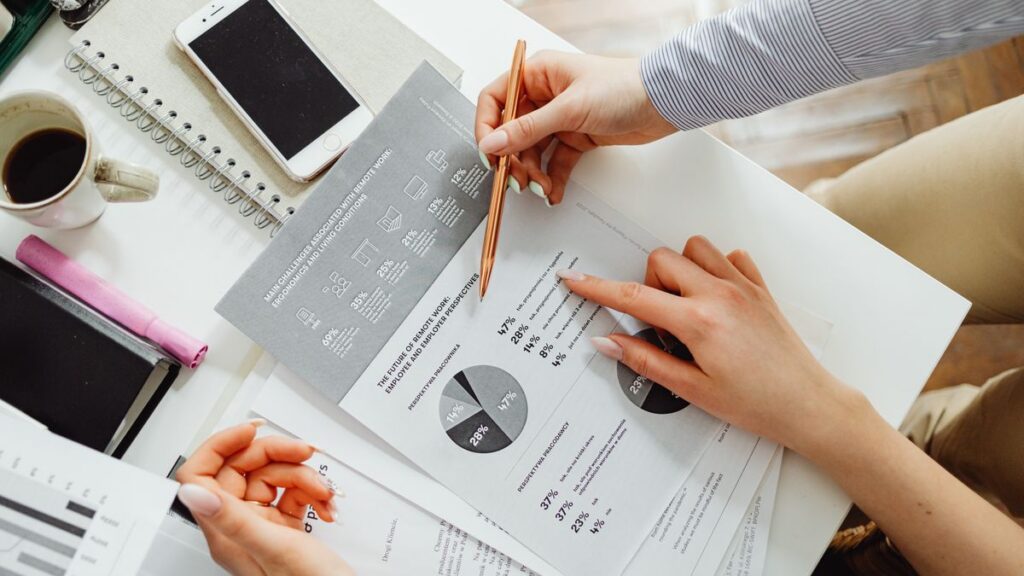 Advisor pointing to charts while reviewing 2027 tax schedules and retirement plan limits