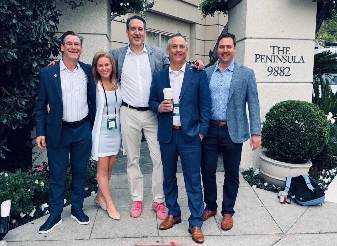 A group of advisors outside an event venue